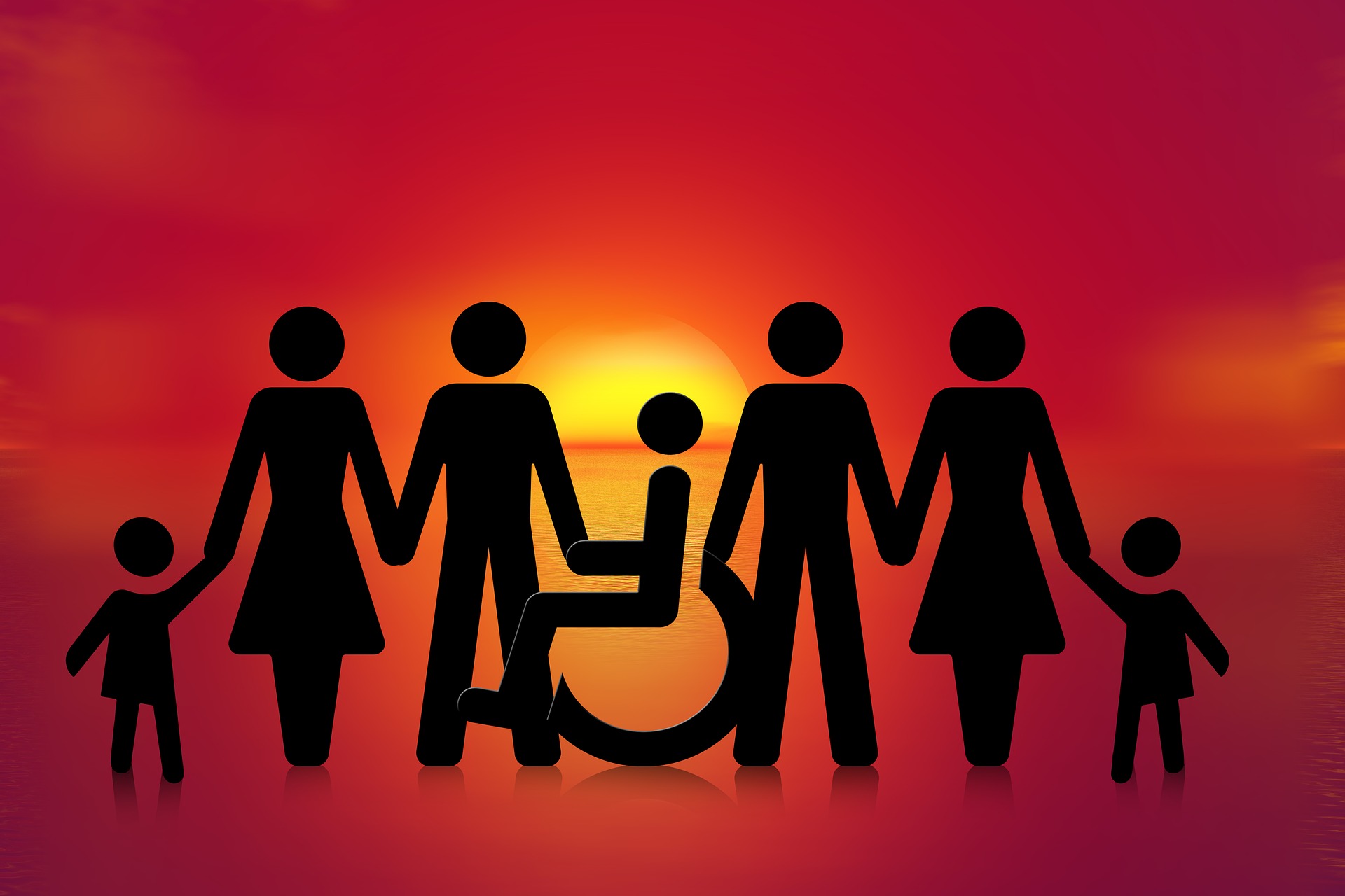 People holding hands in a line including a person in a wheelchair